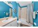 Bright blue bathroom with a tub/shower combination and nautical-themed decor at 6521 Oelsner St, New Port Richey, FL 34652