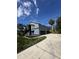 Exterior view of a two-story home with a 3-car garage at 6521 Oelsner St, New Port Richey, FL 34652
