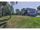 Charming two-story home with ample front lawn, complemented by mature trees at 6521 Oelsner St, New Port Richey, FL 34652