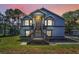 Charming two-story home with a well-manicured lawn and inviting staircase leading to the front door at 6521 Oelsner St, New Port Richey, FL 34652