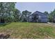 Two-story home with blue exterior, front porch, and spacious landscaped lawn at 6521 Oelsner St, New Port Richey, FL 34652