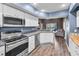 Well-equipped kitchen with modern stainless steel appliances and sleek countertops for culinary enthusiasts at 6521 Oelsner St, New Port Richey, FL 34652