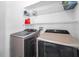 Laundry room featuring front-load washer and dryer with storage shelving at 6521 Oelsner St, New Port Richey, FL 34652