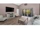 Cozy living room with laminate wood flooring, a sliding glass door, and natural lighting at 6521 Oelsner St, New Port Richey, FL 34652