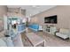 Spacious living room featuring an open layout, wood floors, and a stylish entertainment center at 6521 Oelsner St, New Port Richey, FL 34652