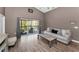 Comfortable living room with wood floors and access to the outdoor deck, perfect for relaxation and entertaining at 6521 Oelsner St, New Port Richey, FL 34652