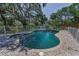 Swimming pool with brick surround and metal fencing at 6521 Oelsner St, New Port Richey, FL 34652