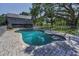 Backyard pool with lounge area and a view of the house, fenced for privacy and safety at 6521 Oelsner St, New Port Richey, FL 34652