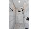 Walk-in shower featuring sleek gray tiling and modern matte black fixtures at 6521 Oelsner St, New Port Richey, FL 34652