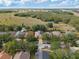Neighborhood aerial view showcasing a home nestled among mature trees near a field and a distant highway for easy commutes at 6914 Monarch Park Dr, Apollo Beach, FL 33572