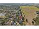 Aerial view of a residential neighborhood adjacent to a green space at 6914 Monarch Park Dr, Apollo Beach, FL 33572