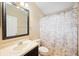 This bathroom features a vanity with sink, toilet, and shower with decorative shower curtain at 6914 Monarch Park Dr, Apollo Beach, FL 33572