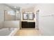 Bathroom featuring a soaking tub, glass shower, and double vanity sinks at 6914 Monarch Park Dr, Apollo Beach, FL 33572