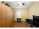 Bedroom showcasing ample storage with built-in cabinets, along with a window for natural light and hardwood flooring at 6914 Monarch Park Dr, Apollo Beach, FL 33572