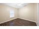 Spare bedroom featuring a ceiling fan, window, and hardwood floors at 6914 Monarch Park Dr, Apollo Beach, FL 33572