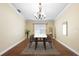 Elegant dining room featuring modern chandelier, wood floors, and neutral decor at 6914 Monarch Park Dr, Apollo Beach, FL 33572