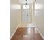 Bright entryway featuring hardwood floors, high ceilings, and a modern chandelier at 6914 Monarch Park Dr, Apollo Beach, FL 33572