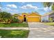 Charming one-story home features a two-car garage and beautifully landscaped front yard at 6914 Monarch Park Dr, Apollo Beach, FL 33572