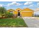Charming one-story home features a two-car garage and beautifully landscaped front yard at 6914 Monarch Park Dr, Apollo Beach, FL 33572
