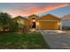 Charming one-story home features a two-car garage and beautifully landscaped front yard at 6914 Monarch Park Dr, Apollo Beach, FL 33572