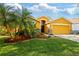 Charming one-story home features a two-car garage and beautifully landscaped front yard at 6914 Monarch Park Dr, Apollo Beach, FL 33572