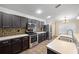 Well-equipped kitchen with stainless steel appliances, and dark wood cabinetry at 6914 Monarch Park Dr, Apollo Beach, FL 33572