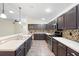 Open kitchen features dark wood cabinets, stainless steel appliances and decorative backsplash at 6914 Monarch Park Dr, Apollo Beach, FL 33572