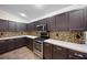 Kitchen area showcasing dark wood cabinets, stainless steel appliances and decorative backsplash at 6914 Monarch Park Dr, Apollo Beach, FL 33572