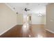 Open-concept living room featuring hardwood floors, a ceiling fan, and natural light at 6914 Monarch Park Dr, Apollo Beach, FL 33572