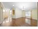 Spacious living room with hardwood floors, chandelier, and built-in shelving at 6914 Monarch Park Dr, Apollo Beach, FL 33572