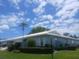 Beautiful single-story home with lush landscaping, manicured bushes, and a well-maintained lawn at 804 67Th W St, Bradenton, FL 34209