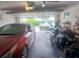 A well-lit two car garage featuring car, motorcycle, and overhead storage at 804 67Th W St, Bradenton, FL 34209