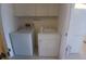 Functional laundry area includes a side-by-side washer and dryer with overhead cabinets at 804 67Th W St, Bradenton, FL 34209