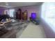 Open living room featuring a checkered rug, TV, natural light, and neutral color scheme at 804 67Th W St, Bradenton, FL 34209