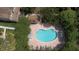 Aerial view of a kidney-shaped community pool surrounded by lush landscaping and lounge chairs at 8545 Hunters Key Cir, Tampa, FL 33647