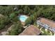 Aerial view showcasing a community pool with surrounding trees and nearby townhouses at 8545 Hunters Key Cir, Tampa, FL 33647