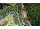 Aerial view featuring townhouses, a parking lot, and tree-lined streets in a community at 8545 Hunters Key Cir, Tampa, FL 33647