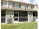 Backyard of home with a screened-in patio area and green grass at 8545 Hunters Key Cir, Tampa, FL 33647