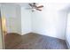 Cozy bedroom with hardwood floors, a ceiling fan, and natural light from a window at 8545 Hunters Key Cir, Tampa, FL 33647