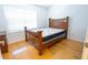 Bedroom with hardwood floors and a wooden bed near a window offering natural light at 8545 Hunters Key Cir, Tampa, FL 33647