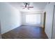 Bright bedroom with a ceiling fan, hardwood floors, and a large window for ample light at 8545 Hunters Key Cir, Tampa, FL 33647