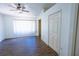 Comfortable bedroom featuring a ceiling fan, hardwood floors, and natural light from a window at 8545 Hunters Key Cir, Tampa, FL 33647