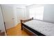 Bedroom features a wooden bed frame, closet, window and light wood floors at 8545 Hunters Key Cir, Tampa, FL 33647