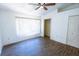 Bright bedroom featuring hardwood floors, a ceiling fan, and a large closet at 8545 Hunters Key Cir, Tampa, FL 33647
