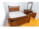 Bedroom featuring a wooden bed frame, dresser, mirror, and light wood floors at 8545 Hunters Key Cir, Tampa, FL 33647