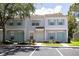 Charming townhome featuring a well-maintained exterior with colorful shutters and a lush green landscape at 8545 Hunters Key Cir, Tampa, FL 33647