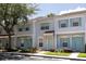 Beautiful townhome showcasing a well-kept lawn, tidy landscaping, and reserved parking for residents at 8545 Hunters Key Cir, Tampa, FL 33647