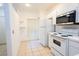 A bright kitchen featuring tiled flooring, white appliances and ample cabinet and storage space at 8545 Hunters Key Cir, Tampa, FL 33647