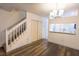 Bright living area featuring hardwood floors, staircase, and modern lighting fixture at 8545 Hunters Key Cir, Tampa, FL 33647