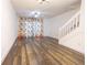 A bright living room with an adjacent staircase, neutral walls and sleek hardwood floors at 8545 Hunters Key Cir, Tampa, FL 33647